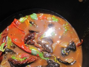 3 types of peppers simmering in chicken broth, herbs & spices